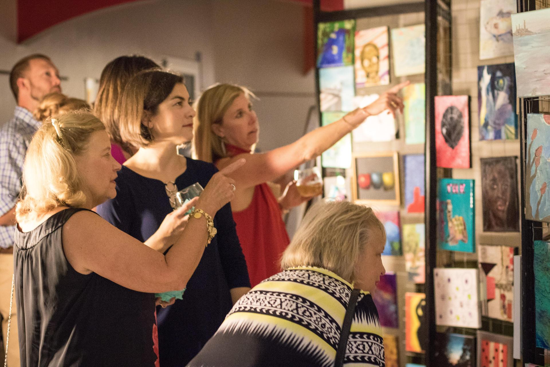 Community Creates 2026 fundraiser event at Arts Based School Winston-Salem with attendees viewing art